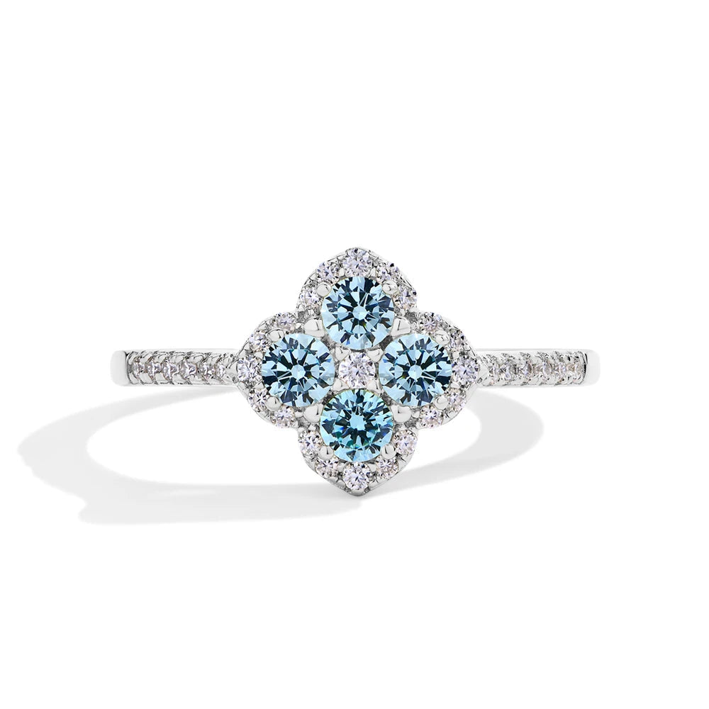 Diamond ring with blue gemstones on a white background, branded mirrorquenn