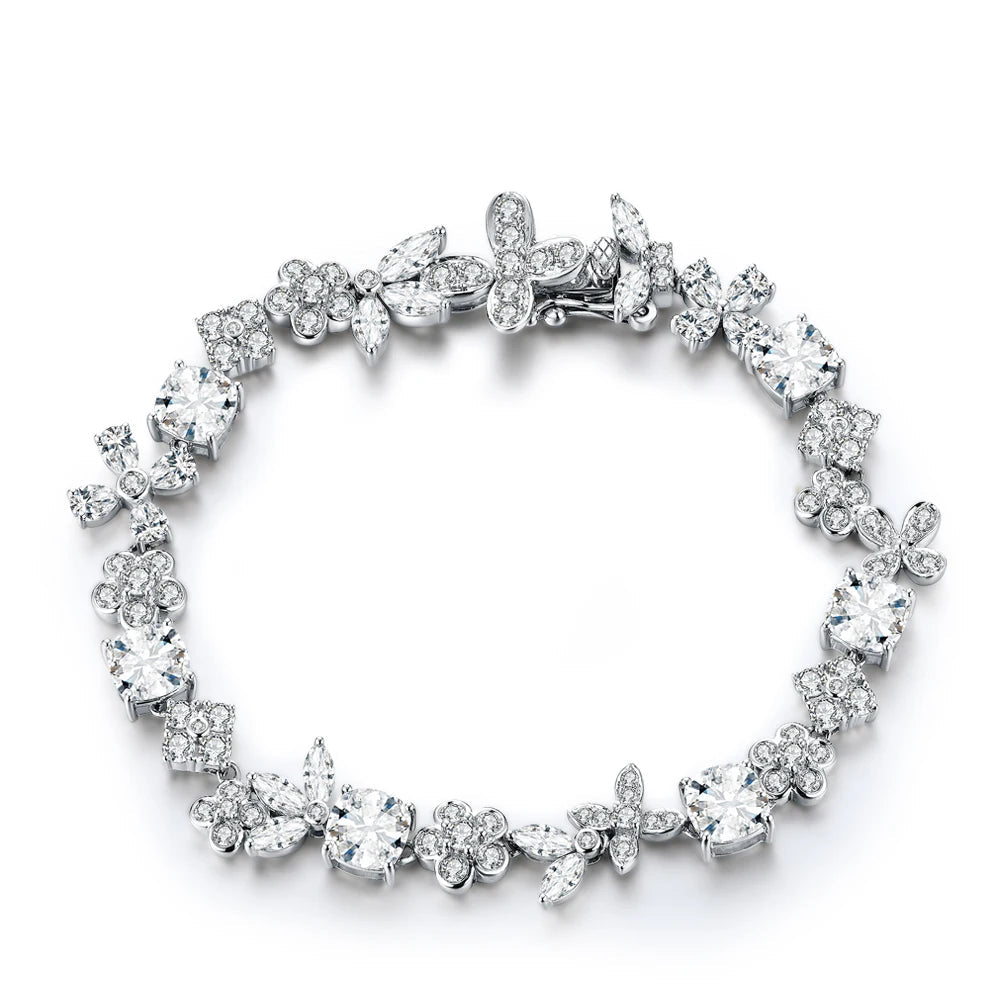 Dainty silver bracelet with clear gemstones on a white background, branded 'MirrorQuenn'.
