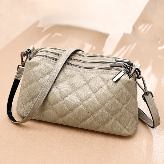 Close-up of the 100% genuine leather texture of the handbag (27cm x 10cm x 13cm)