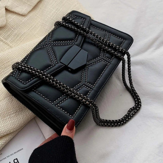  Edgy women's small crossbody bag with rivet and chain details
