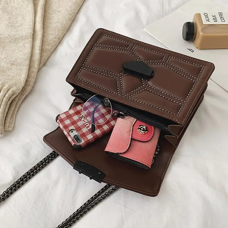 Small crossbody bag with a flap cover and rivet decorations
