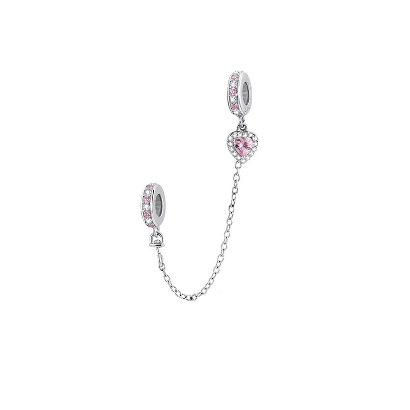 Silver charm with pink gemstones on a white background
